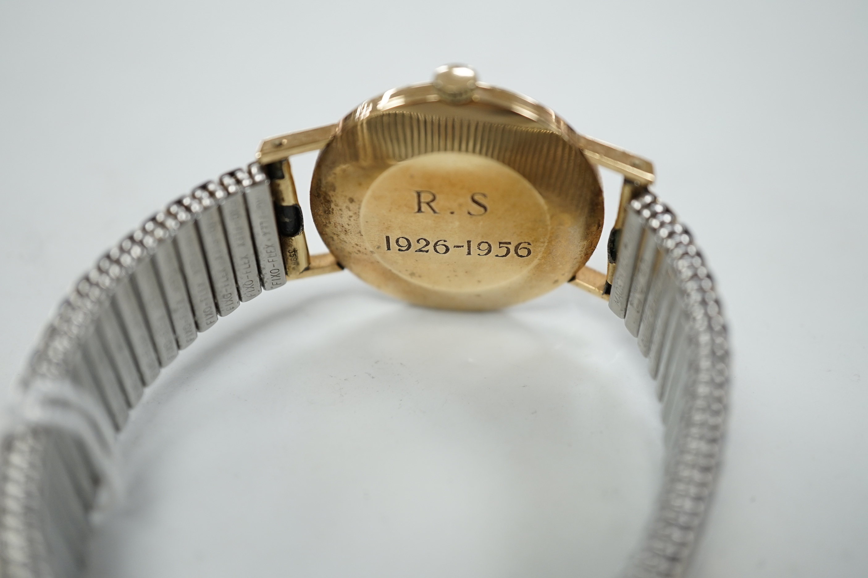 A gentleman's 9ct. gold Longines manual wind wrist watch, with engraved inscription, on an associated strap, boxed.